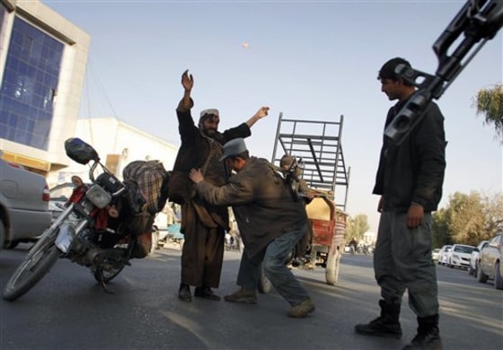 An Afghan policeman frisks a man at a checkpoint in Kandahar, Afghanistan, on Sunday.